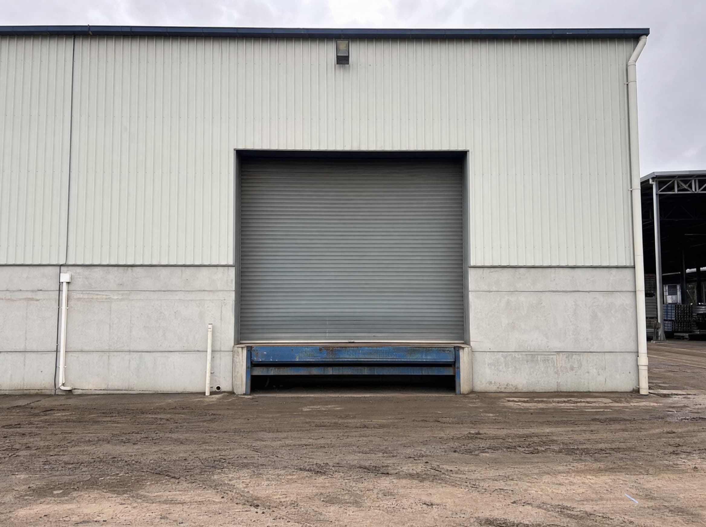 Grimy warehouse loading bay before exterior cleaning in Rutherford
