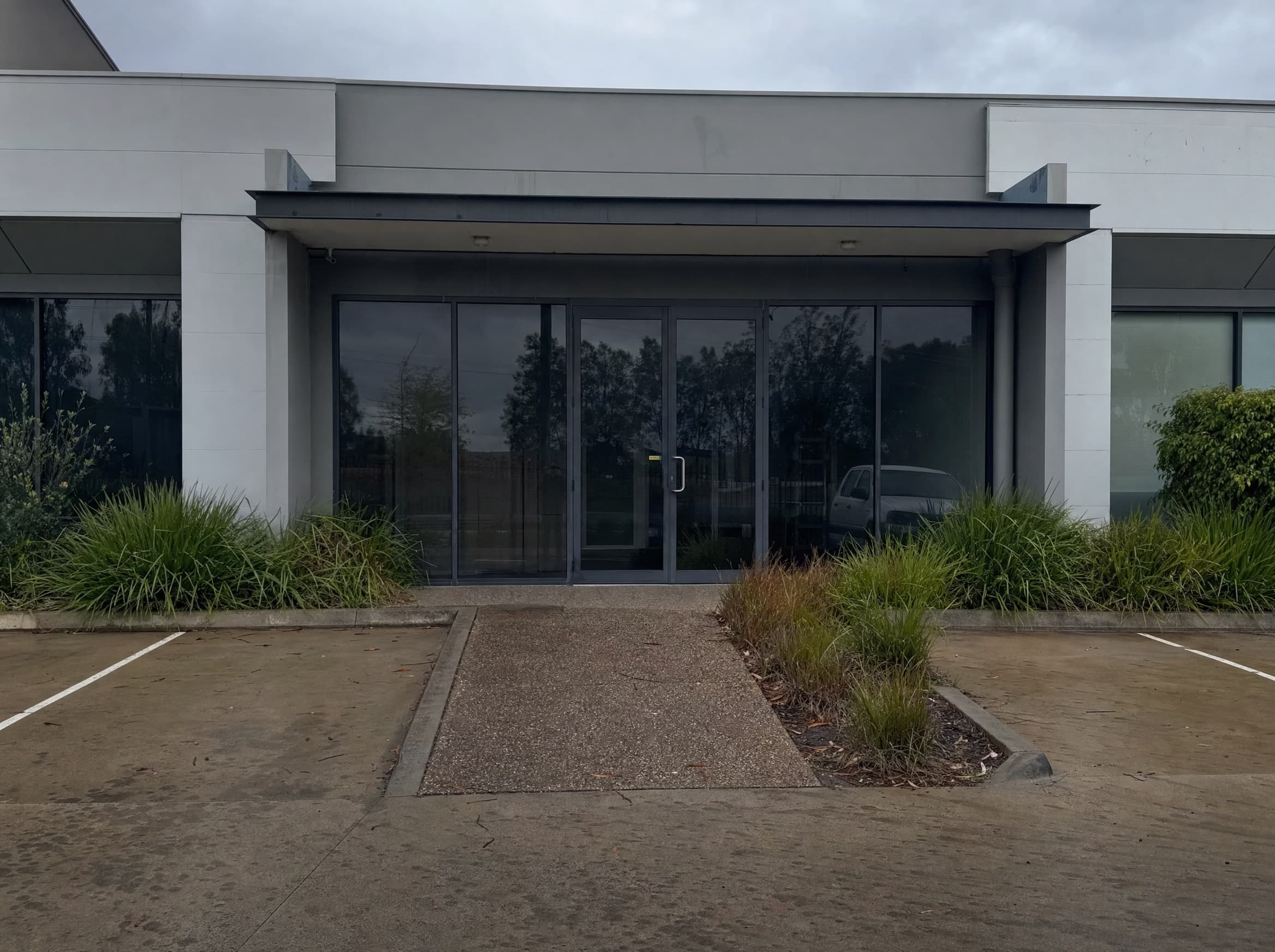 Stained exposed aggregate path before cleaning in Cessnock