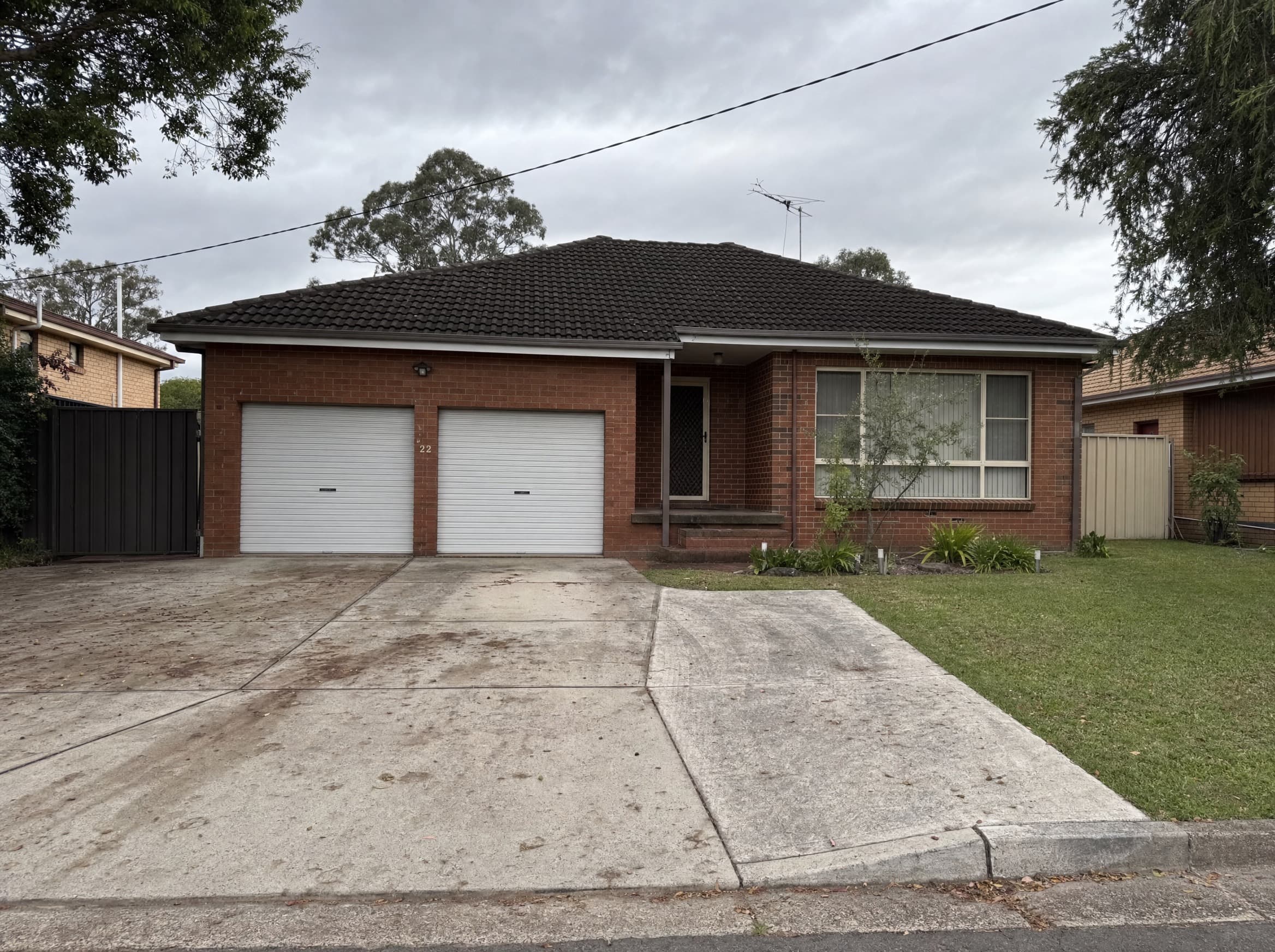 Stained concrete driveway before cleaning in New Lambton, Newcastle